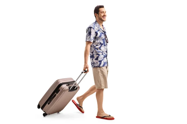 Tourist walking and pulling a suitcase — Stock Photo, Image