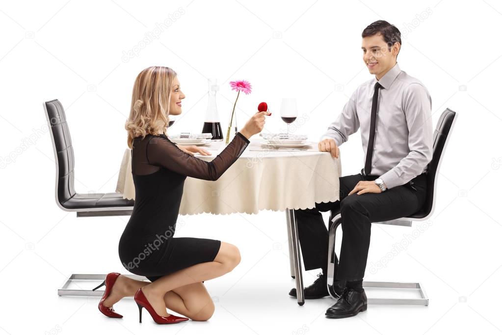 woman kneeling and proposing to her boyfriend