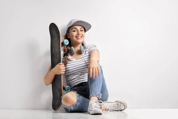 Dospívající dívka s skateboard a sluchátka — Stock fotografie