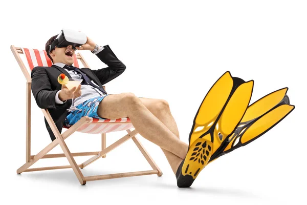 Businessman sitting in a deck chair and using VR headset — Stock Photo, Image