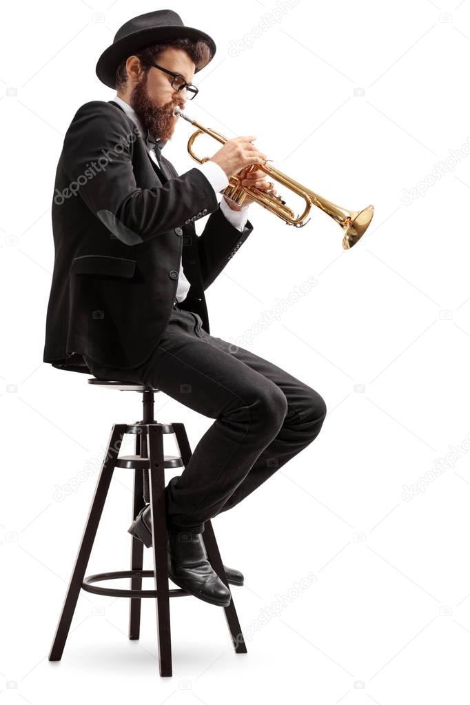 Trumpet player sitting on a chair — Stock Photo © ljsphotography 161344584