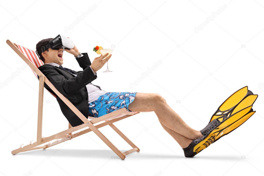 Businessman sitting in a deck chair and using a VR headset