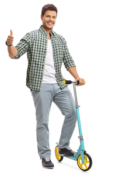 Guy with a scooter making a thumb up gesture — Stock Photo, Image