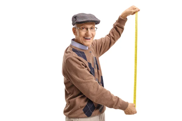 Senior holding a measuring tape — Stock Photo, Image