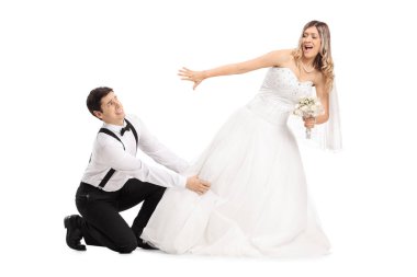 Groom trying to stop his bide from running away clipart