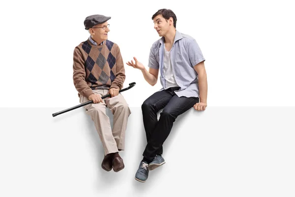 Senior and a man sitting on a panel and talking — Stock Photo, Image