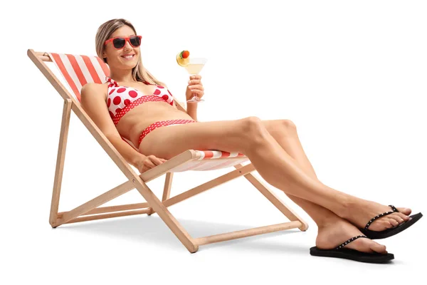 Woman with a cocktail relaxing in a deck chair — Stock Photo, Image