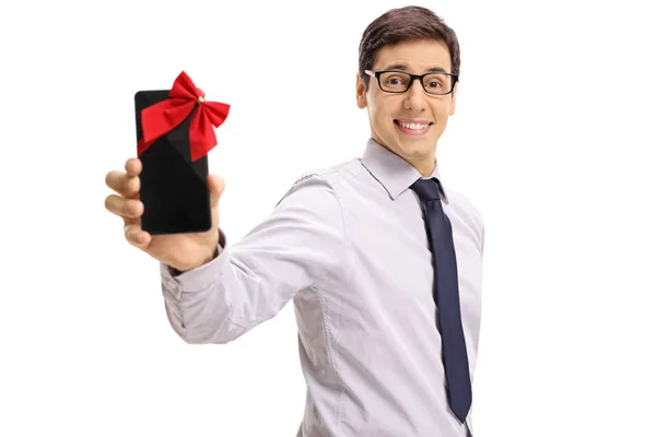 Guy showing phone wrapped with ribbon as gift — Stock Photo, Image