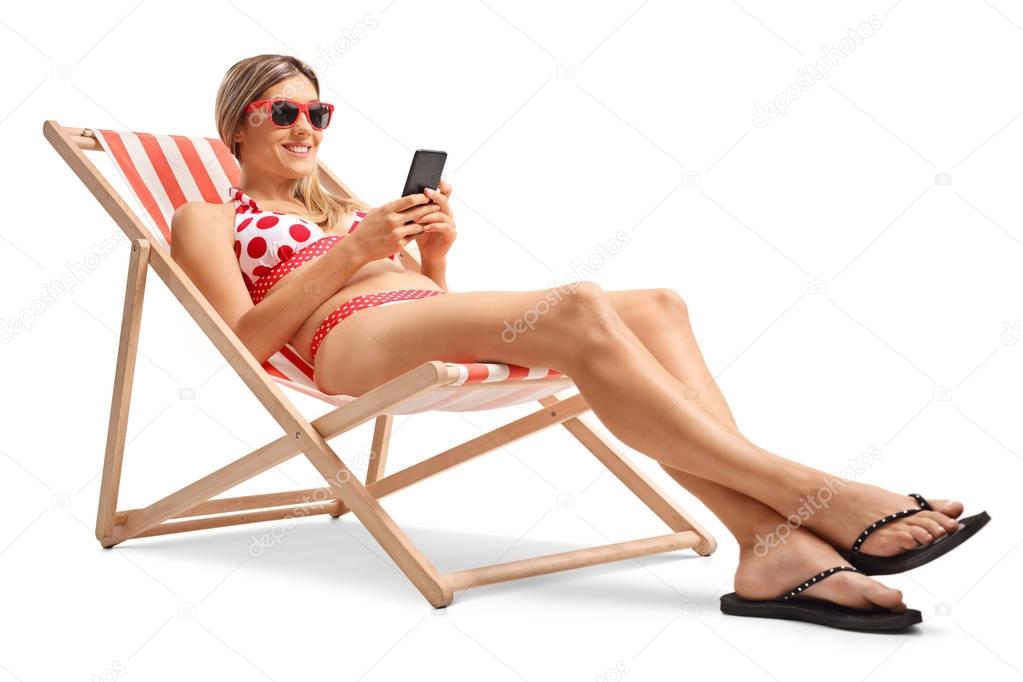 woman with a mobile phone in a deck chair