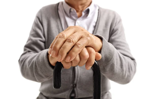 Hands of an elderly man on walking cane — Stock Photo, Image