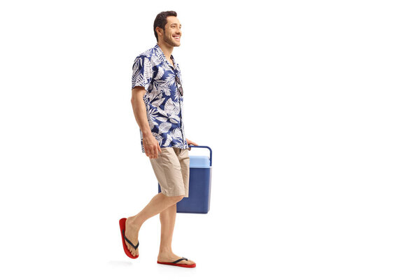 man holding a cooling box and walking