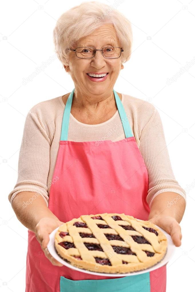 Elderly woman offering pie