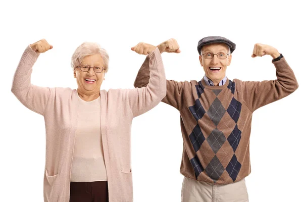 Joyful seniors flexing their biceps — Stock Photo, Image