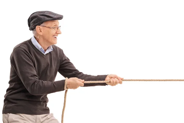 Senior pulling a rope — Stock Photo, Image