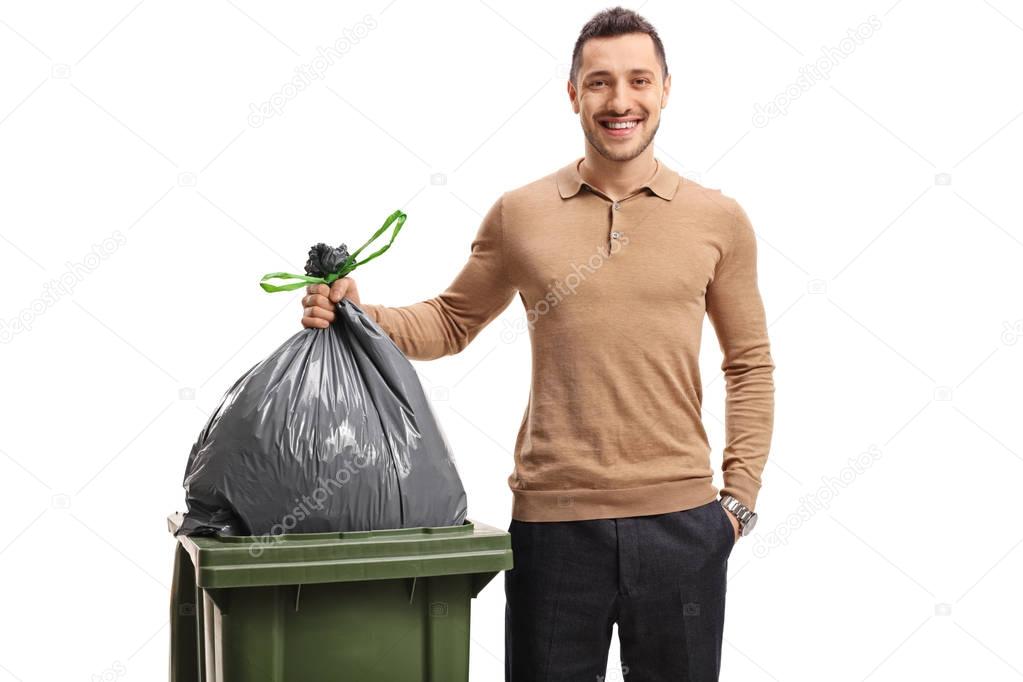man throwing out the garbage and smiling