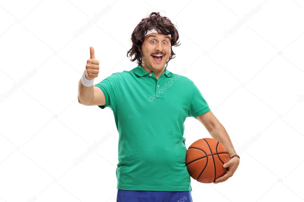 sportsman holding basketball and making thumb up sign