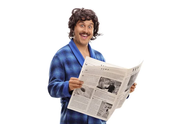 Young man in a bathrobe holding a newspaper — Stock Photo, Image