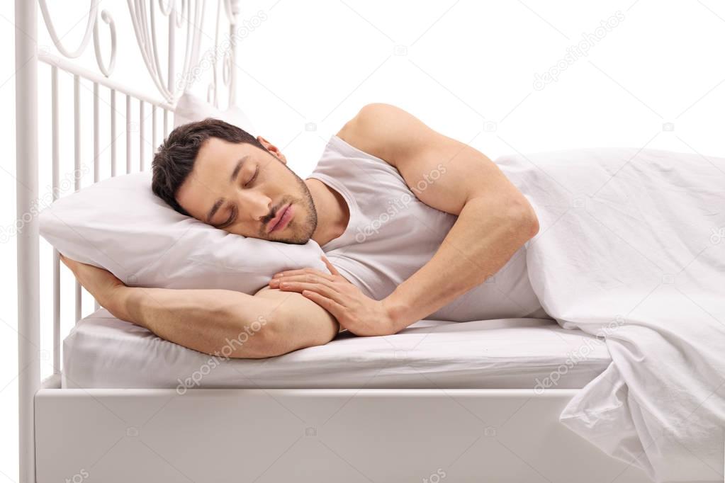 Young man sleeping in a bed