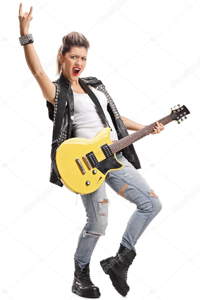 girl with an electric guitar making rock hand gesture