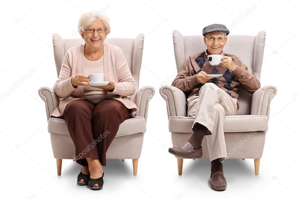 Seniors seated in armchairs drinking tea