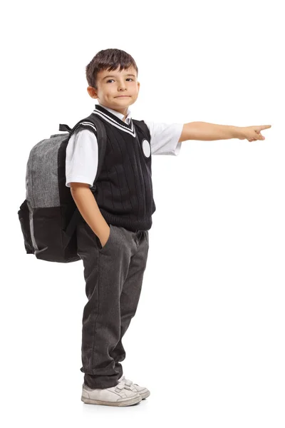 Colegial con una mochila apuntando — Foto de Stock