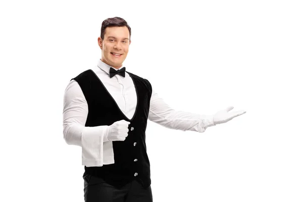 Waiter gesturing with his hand — Stock Photo, Image