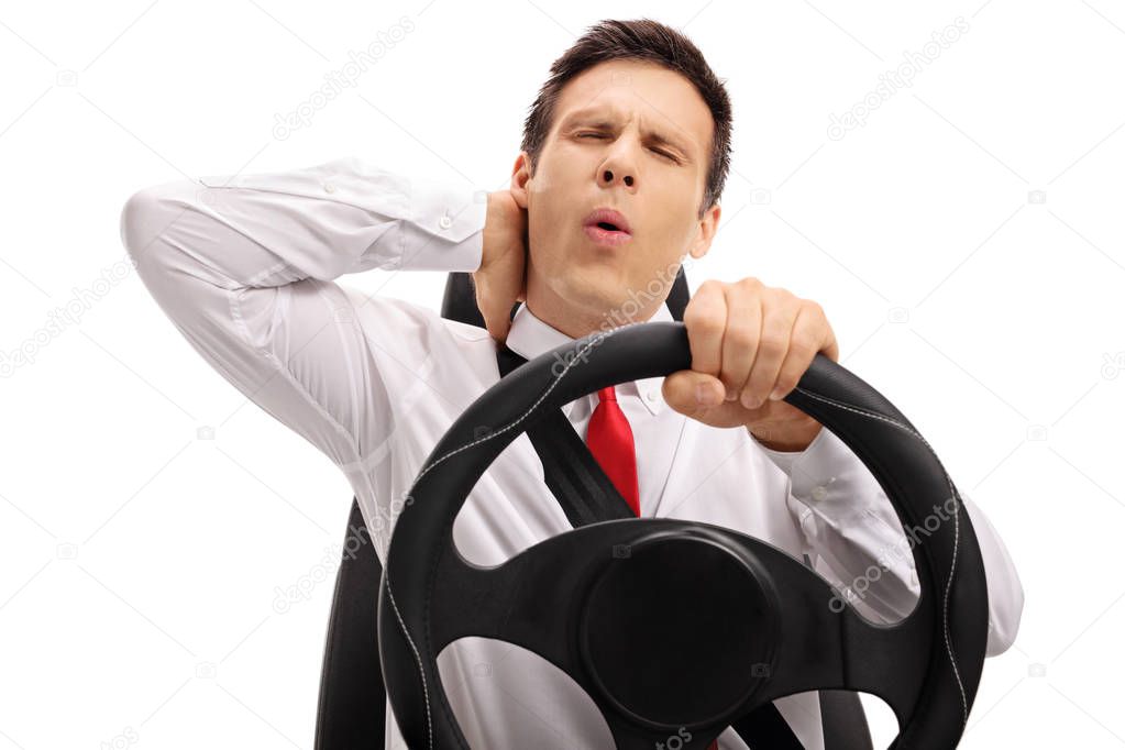 Businessman driving and experiencing neck pain