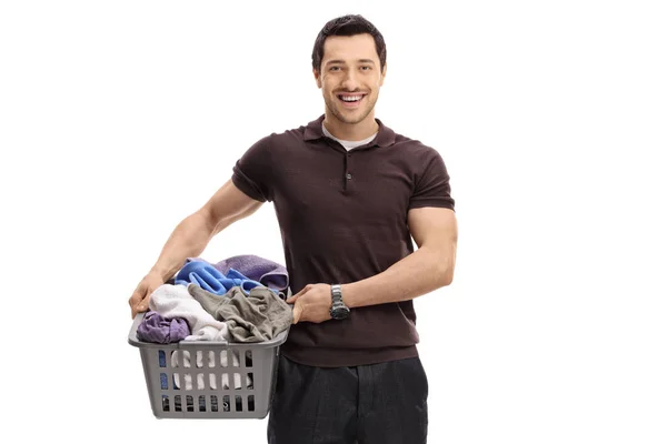 Guy with a laundry basket full of clothes — Stock Photo, Image