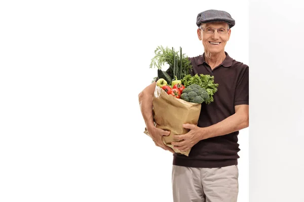 Man håller en papperskasse fylld med dagligvaror — Stockfoto