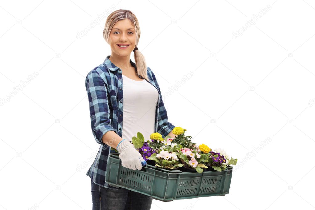 Female gardener with a crate full of flowers