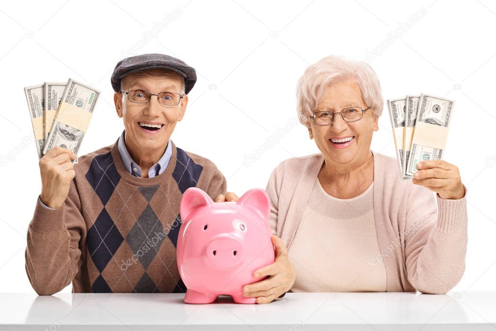 Happy seniors with money bundles and a piggybank