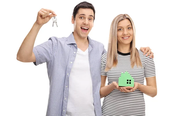 Couple with pair of keys and model house — Stock Photo, Image