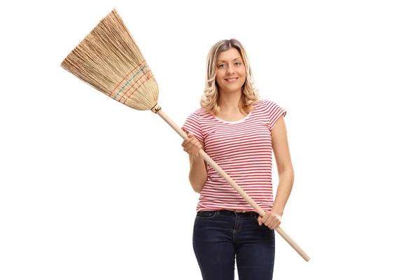Young woman holding a broom — Stock Photo, Image