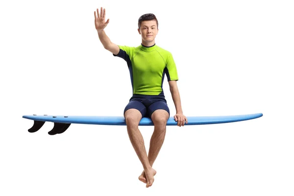 Teenage surfer waving at the camera — Stock Photo, Image