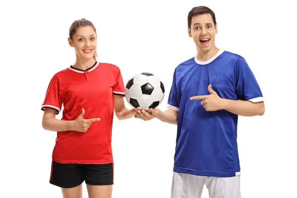 Female footballer and a male footballer pointing — Stock Photo, Image