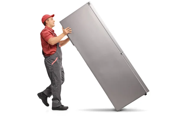 Profile shot of a serviceman with a fridge — Stock Photo, Image