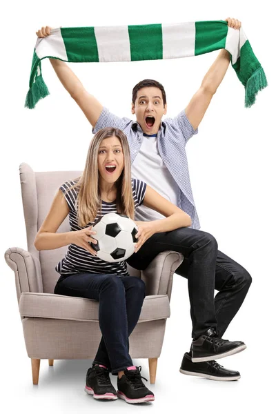 Football fans sitting in an armchair and cheering — Stock Photo, Image