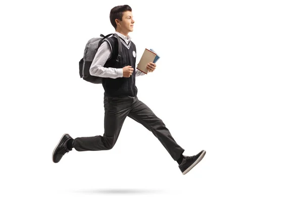 Teenage student with a backpack and books in mid-air — Stock Photo, Image