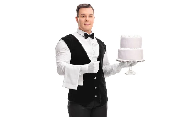 Waiter holding a cake — Stock Photo, Image