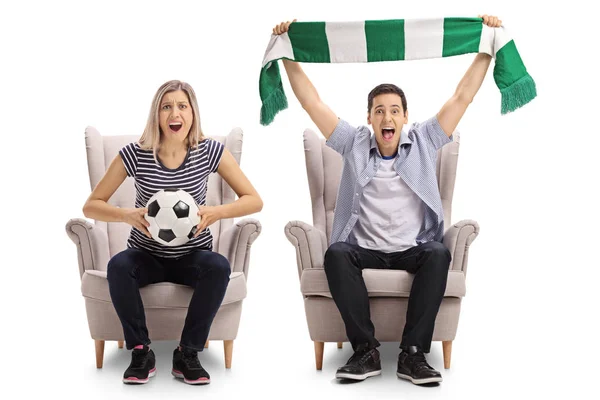 Soccer fans with a football and a scarf sitting in armchairs — Stock Photo, Image