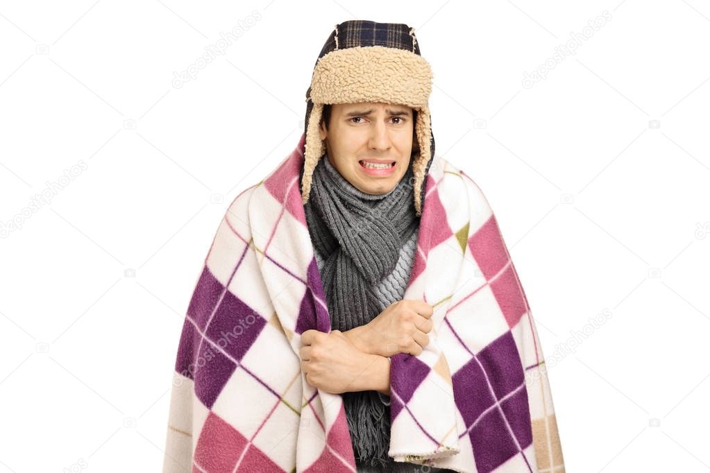 man covered with a blanket feeling cold
