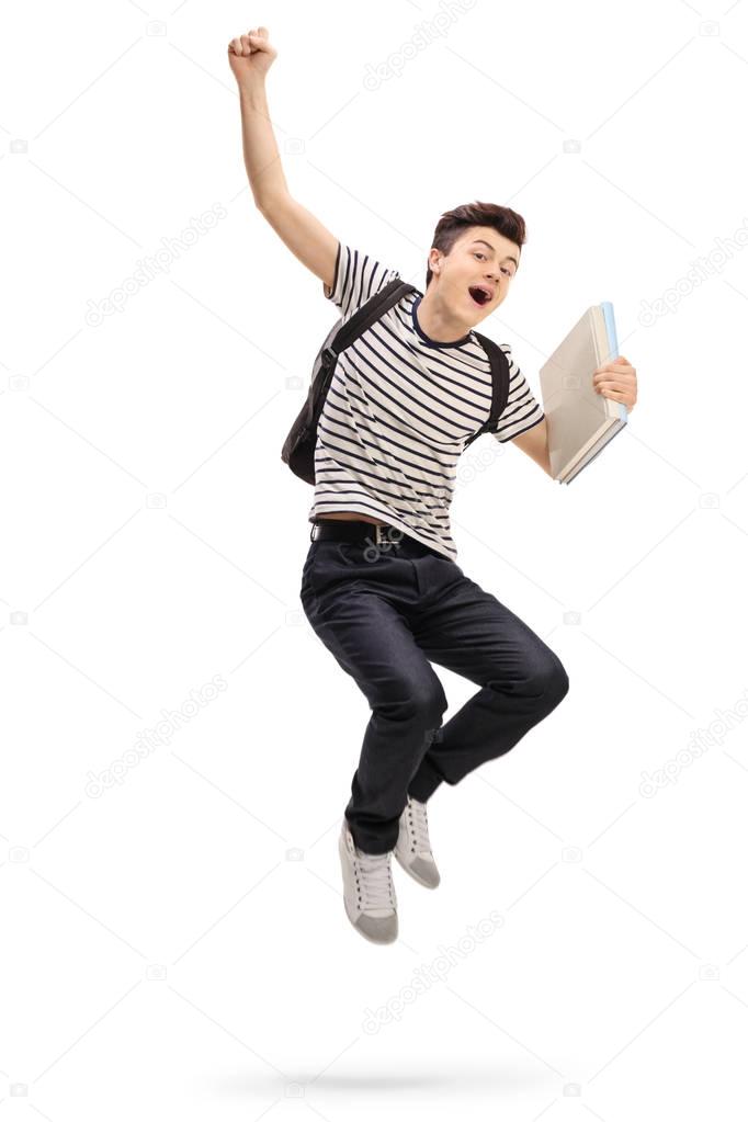 teenage student jumping and gesturing happiness
