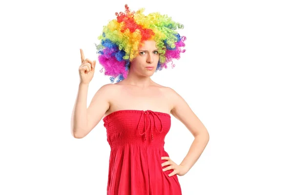 Girl with a wig holding her index finger up — Stock Photo, Image