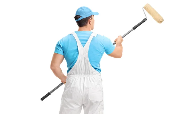 Rear shot of a painter with a paint roller — Stock Photo, Image