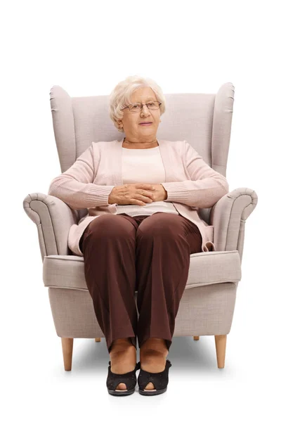 Elderly woman sitting in an armchair — Stock Photo, Image