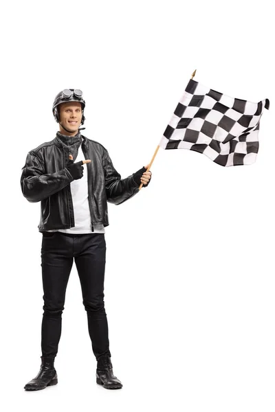 Biker waving a checkered race flag and pointing — Stock Photo, Image