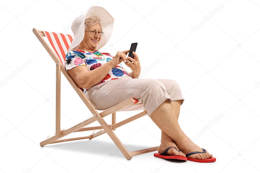 woman sitting in a deck chair and looking at a phone