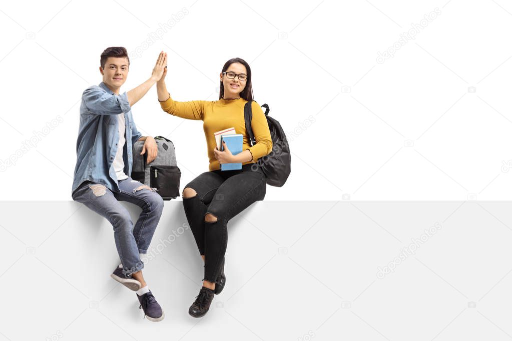Teenage students high-fiving each other