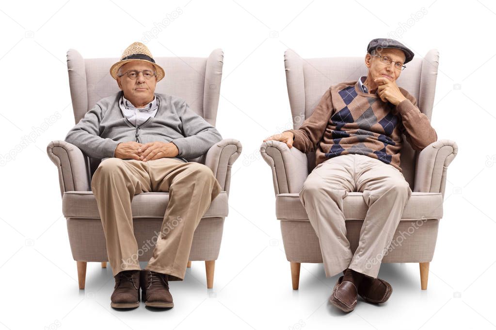 Two elderly men seated in armchairs