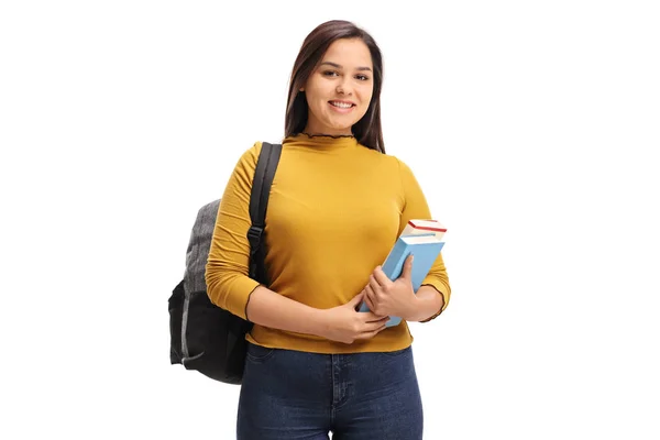 Estudante feminina com uma mochila e livros sorrindo — Fotografia de Stock